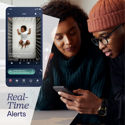 Parents checking Nanit app showing live screen of their baby and shows real-time alerts