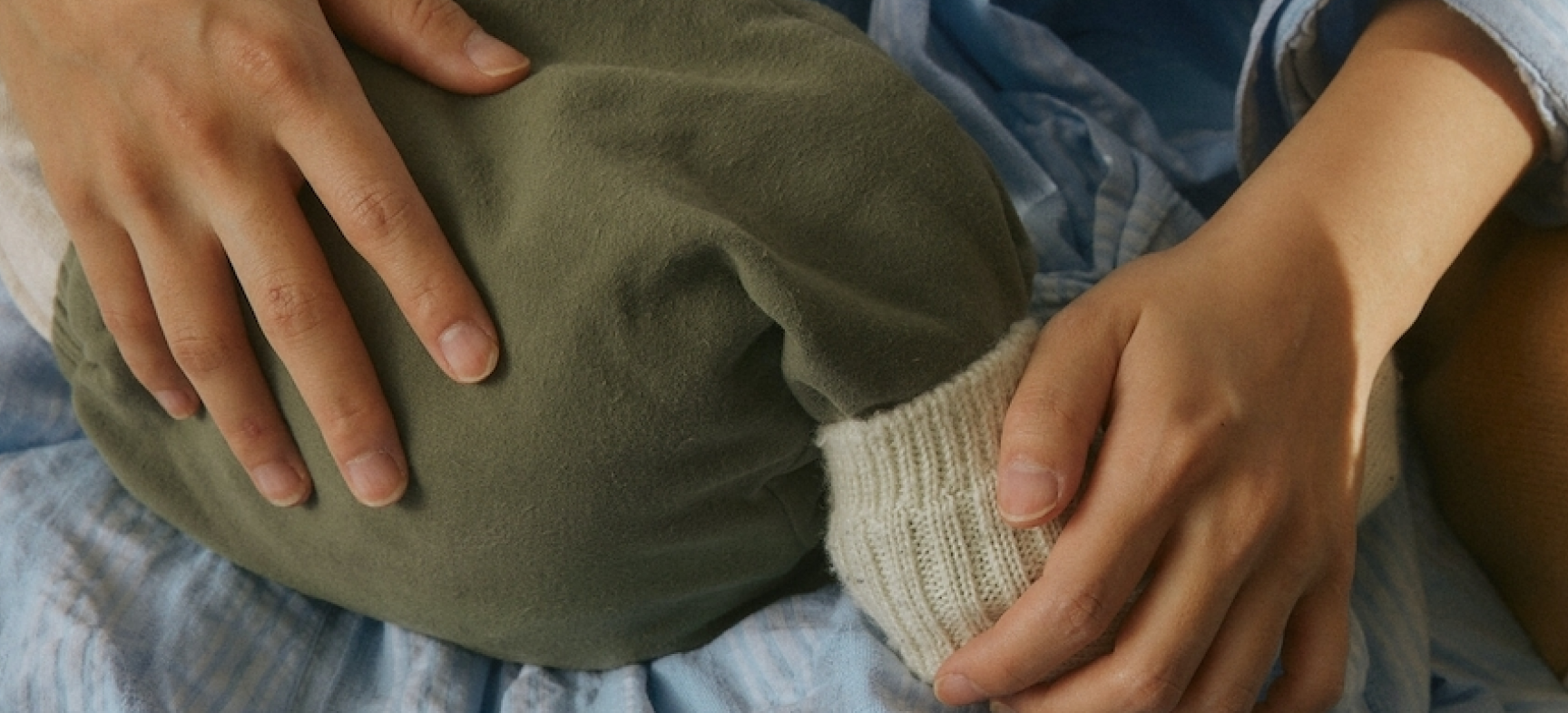 Close up of mom and baby being held with a pair of green pants