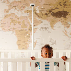  baby in crib with nanit pro camera + floor stand behind #mount_floor stand