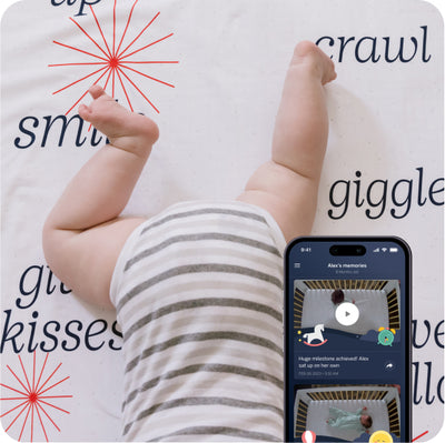 child on blanket with mobile nanit app displayed with view of camera capturing sleep