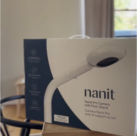 nanit pro camera with floor stand box on top of coffee table