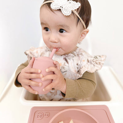 baby drinking from mini cup 