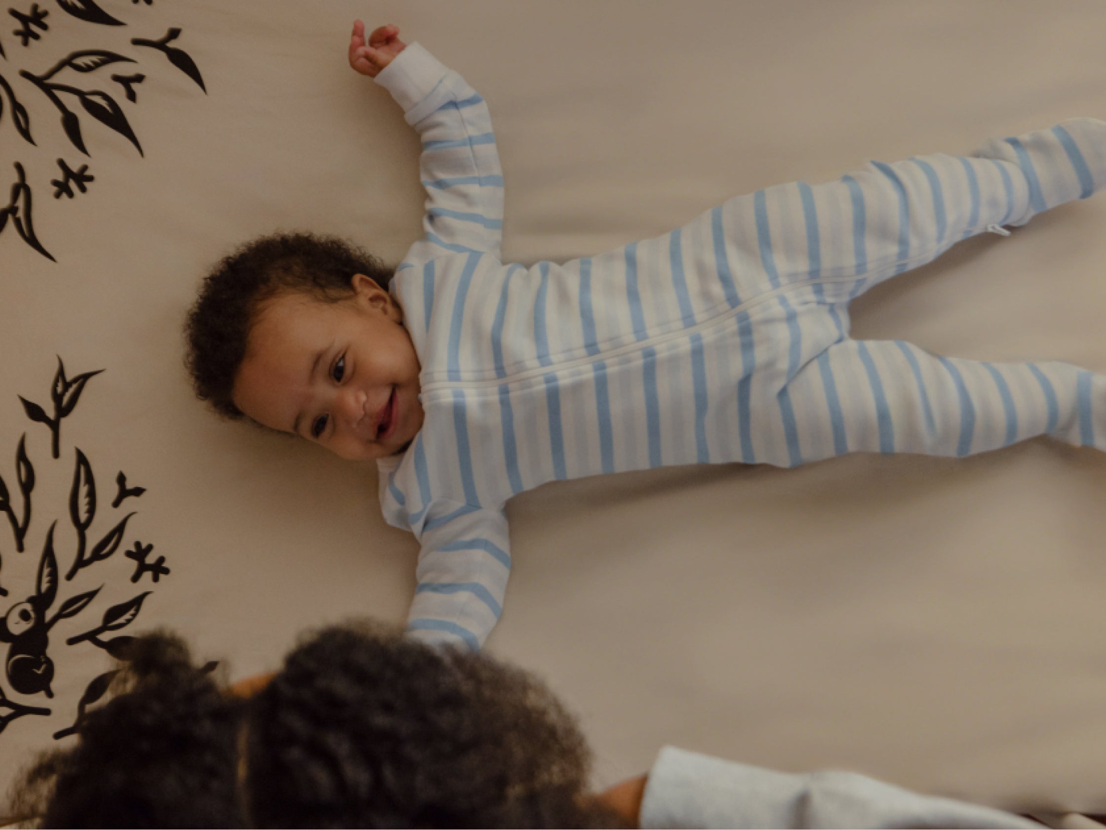 baby smiling while laying in crib