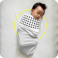 Baby wearing Nanit Breathing Band. Track their head and body position in the crib. Available with Milestones Plan