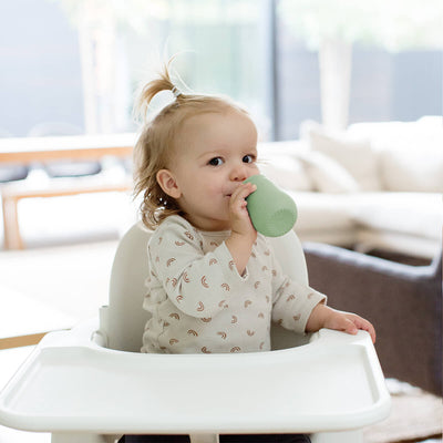 baby drinking from straw from mini cup in sage 