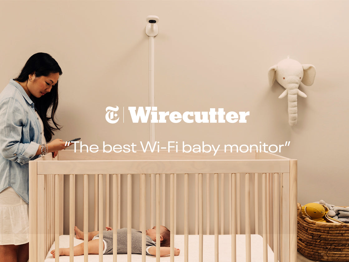 wirecutter - best wifi baby monitor with mom looking at baby in crib