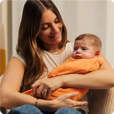 mom holding baby while sitting