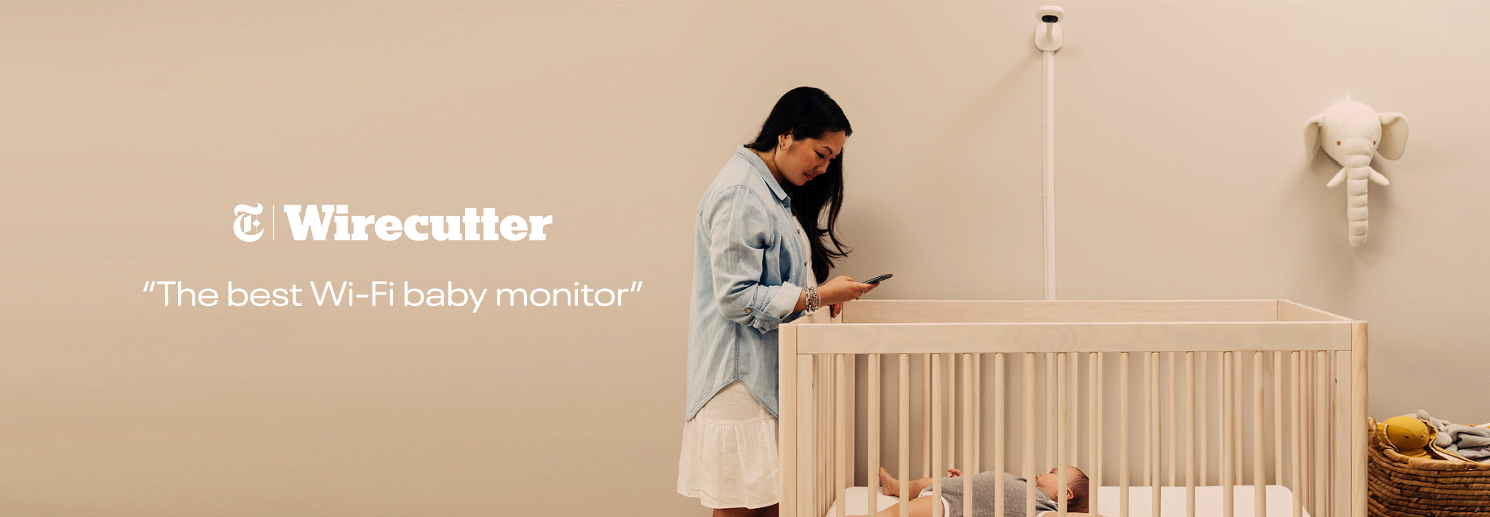 wirecutter - best wifi baby monitor with mom looking at baby in crib